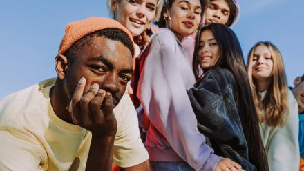 Diverse group of teenagers looking towards the camera as a group