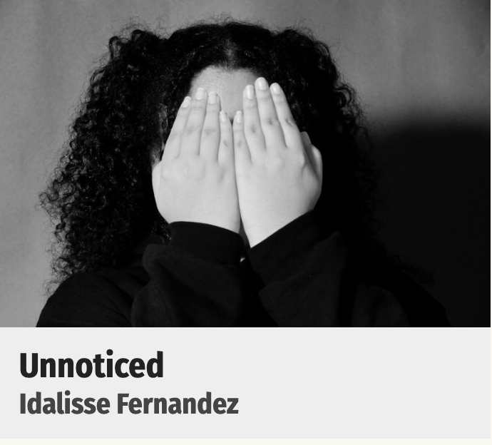 Adolescent girl holding her hands in front of her face