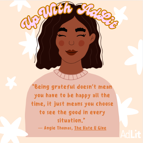 Young AA woman with a quote from The Hate U Give written across her pale pink sweater.