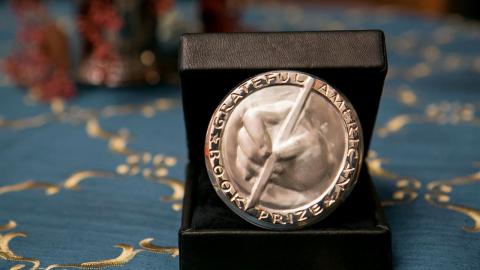 Grateful American Book Prize award silver engraving of handing holding a pen