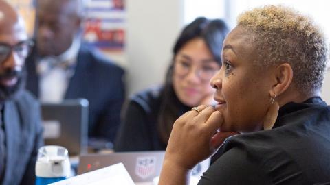 Multicultural group of school leaders and educators talking