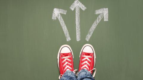 Red converse shoes with three arrows in front pointing in different directions