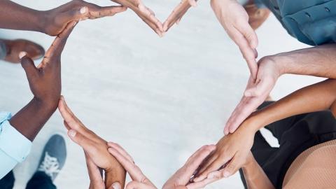 People's hands making the shape of a heart
