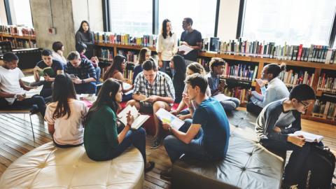 Students and teachers sitting together in the library
