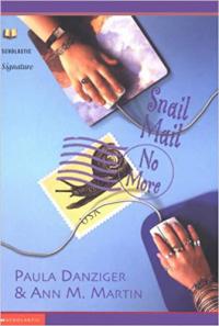 Birds-eye view of girls' hands on journal and computer mouse