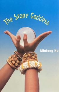 Cambodian girl wearing bracelets holding a crystal orb