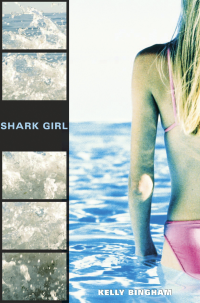 Girl in a pink bikini us wading into water