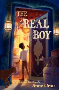 Two cats look on as a young boy walks into a well lit room