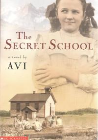 Early 19th century young girl standing with her arms crossed with a one room school house in the foreground.
