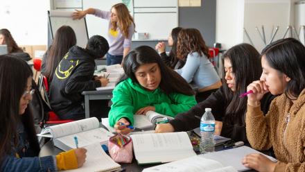 Multicultural high school classroom with active discussion groups