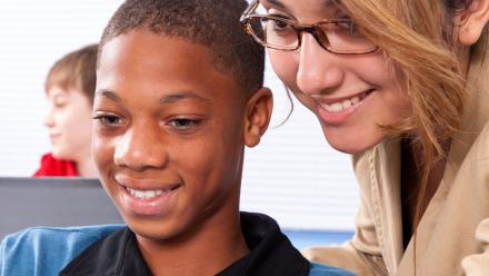 High school teacher working closely with ELL student