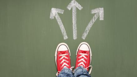 Red converse shoes with three arrows in front pointing in different directions