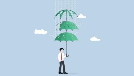 man walking with three umbrellas