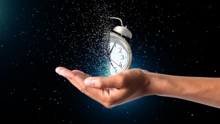 clock fading away while being held in a person's hand