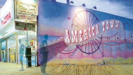 Shadows of young men standing on a boardwalk 