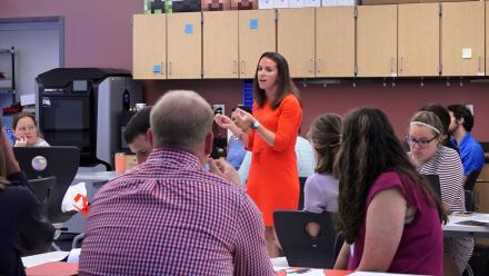 Principal speaking with her faculty in a large group setting