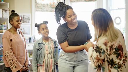 parent with her daughters, meeting their teacher