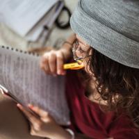 Middle school student at home reading school text