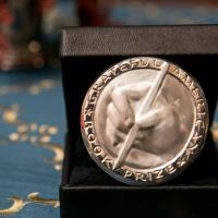 Grateful American Book Prize award silver engraving of handing holding a pen