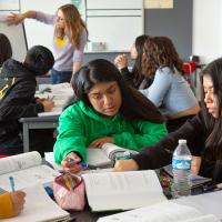 Multicultural high school classroom with active discussion groups