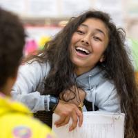 Latina high school student talking with classmate
