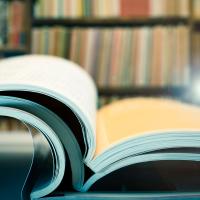 stack of open journals in a library