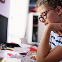 high school student reading text passage at home
