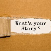 cork board with middle scratched to reveal the title "What's Your Story?"