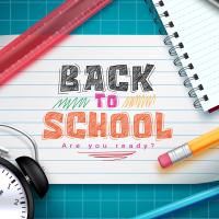 Back to School written on a notecard with a ruler, pencil, and alarm clock 
