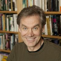 Headshot of John Coy in front of bookcase