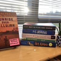 five YA books on display in the classroom with a sticky note on one cover