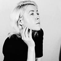 headshot of Courtney Summers in a black shirt looking away from the camera