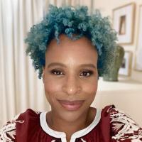 picture of the author with blue hair and wearing a burgandy and white dress.