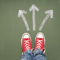 Red converse shoes with three arrows in front pointing in different directions