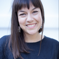 head shot of nina lacour wearing a navy shirt and smiling towards the camera