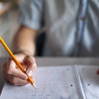 Young man writing a multi-paragraph essay