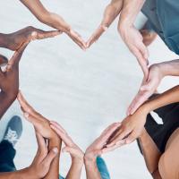 People's hands making the shape of a heart