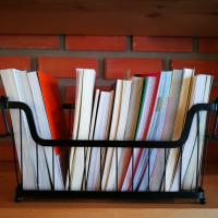 Wire basket with several books in it