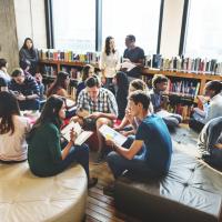 Students and teachers sitting together in the library
