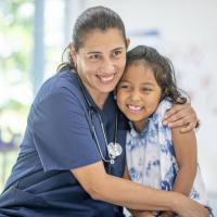 School nurse giving a young girl a young of reassurance