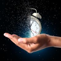 clock fading away while being held in a person's hand