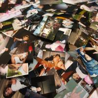 family photographs unorganized and sprawled across a table