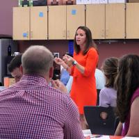 Principal speaking with her faculty in a large group setting