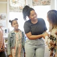 parent with her daughters, meeting their teacher